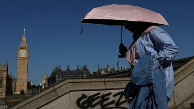 A person uses an umbrella to shield from the sun as they walk near the Elizabeth Tower -more commonly known as Big Ben - and the Houses of Parliament, whilst near drought conditions continue in many parts of the UK, in London, Britain, July 29, 2026. (REUTERS)
