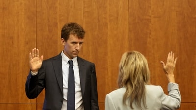 Patrick Clancy, the father of Cora, Dawson and Callan Clancy, is sworn in during Lindsay Clancy's murder trial Plymouth Superior Court, in Plymouth, Massachusetts on July 29. (via REUTERS)