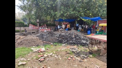 The material has remained unattended since May after road recarpeting. Residents cite respiratory issues, while MCG says removal will begin after monsoon. (HT) The material has remained unattended since May after road recarpeting. Residents cite respiratory issues, while MCG says removal will begin after monsoon. (HT)