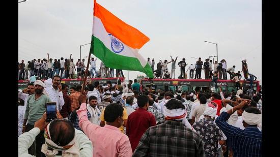 Farmers stand atop a bus as they stage a protest to press for various demands in Bhopal in Madhya Pradesh on Wednesday. (PTI)