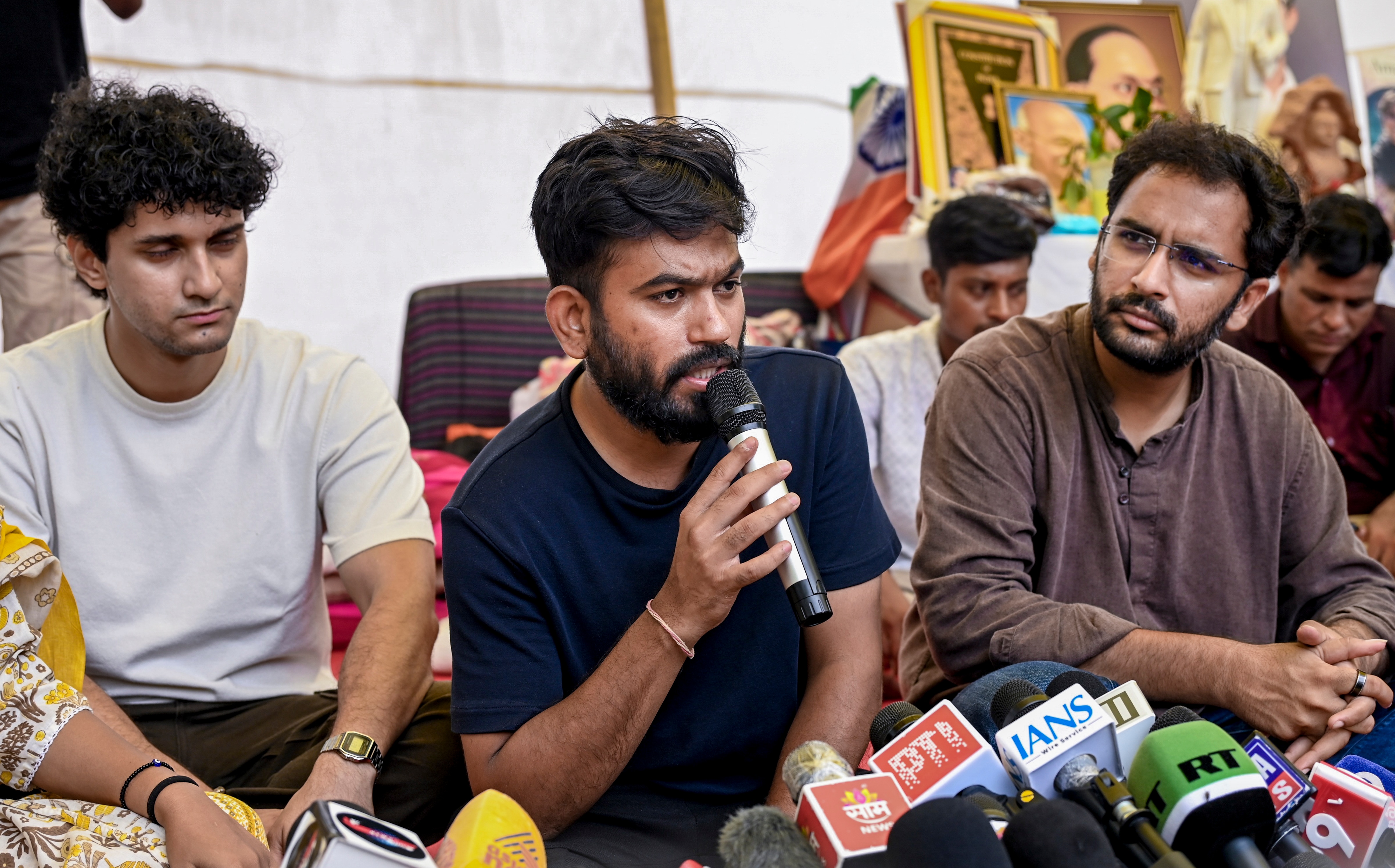Cockroach Janta Party (CJP) founder Abhijeet Dipke addresses a press conference as party spokepersons Saurav Das and Ashutosh Ranka look on, amid the ongoing protest over NEET paper leak issue, at Jantar Mantar. (PTI)