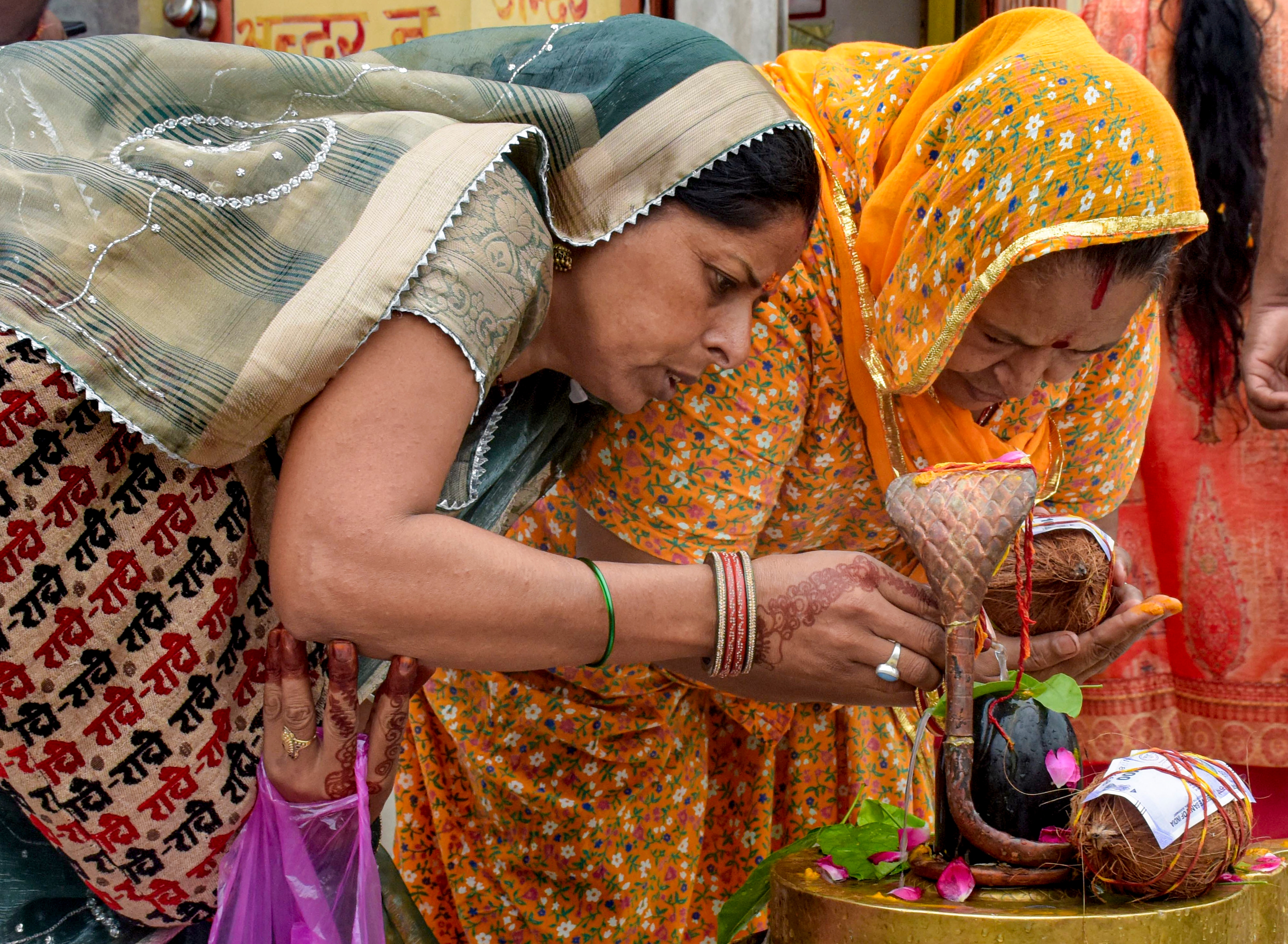 Women offer prayers to Lord Shiva during the annual 'Kanwar Yatra', at Har Ki Pauri, in Haridwar, Uttarakhand. (PTI)
