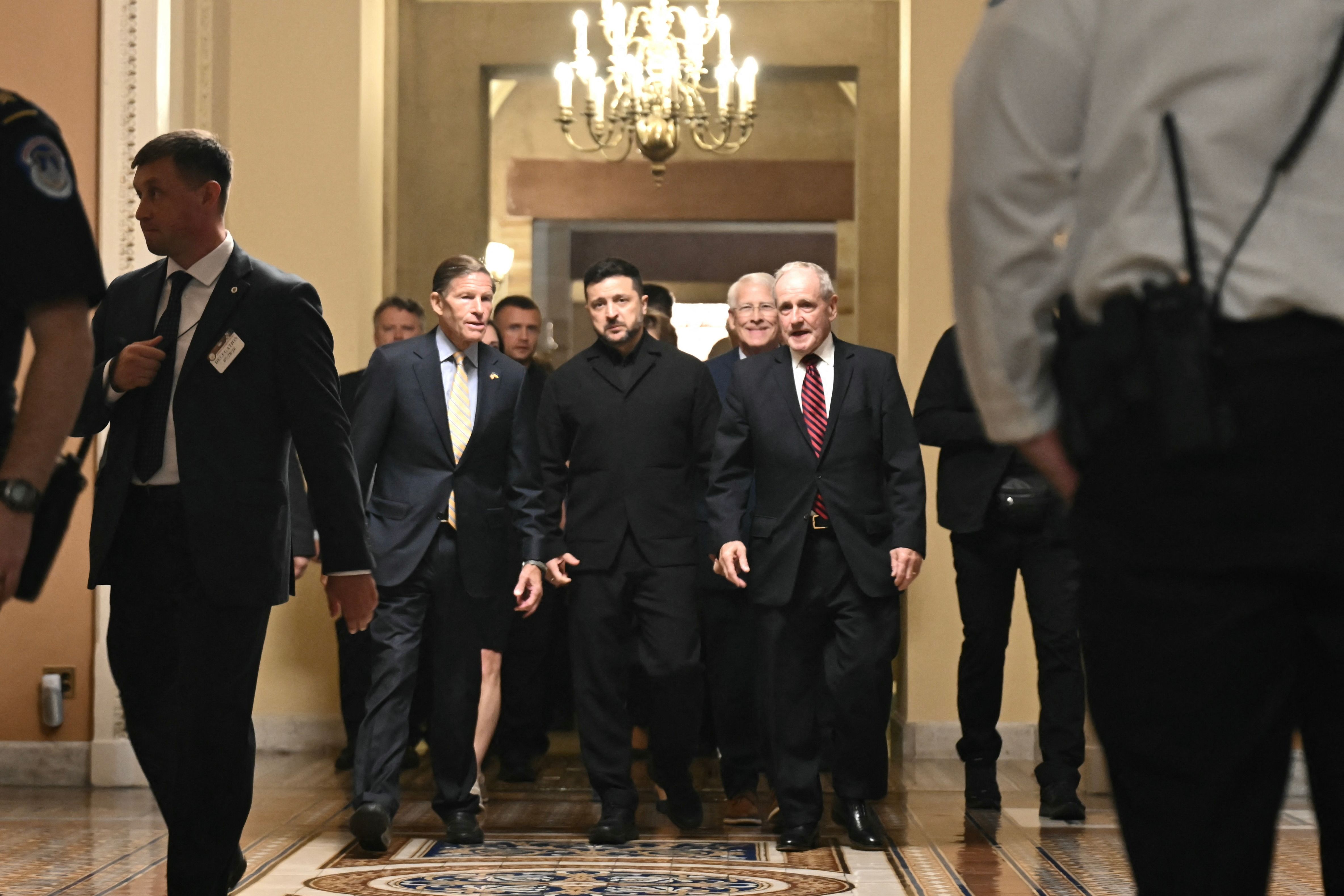 Ukrainian President Volodymyr Zelensky (C) walks with US Senator Richard Blumenthal (D-CT) and US Senator James Risch (R-ID) before a meeting with senators at the US Capitol in Washington. (AFP)