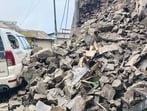 A parked vehicle damaged after the retaining wall collapse at Shimla’s Dhalli on Wednesday. (Deepak Sansta/HT)