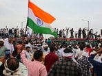 Farmers stand atop a bus as they stage a protest to press for various demands in Bhopal in Madhya Pradesh on Wednesday. (PTI)