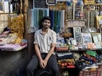 Meraj, 22, has been helping his father run the stall while hunting for a job. (HT Photo)