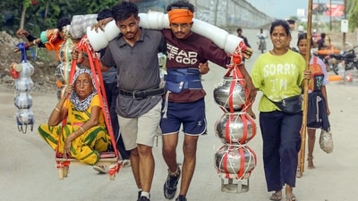 Brothers carry their grandmother in a traditional kanwar while carrying holy water to Noida from Haridwar. (ANI Photo)