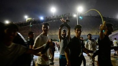 Migrants from Morocco react as they crossed into Ceuta by sea, at the border between the Spanish enclave of Ceuta and Morocco, as seen from Ceuta, Spain, July 30. (REUTERS)