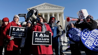 FILE - Pro-abortion and anti-abortion protestors rally outside the Supreme Court in Washington, Wednesday, Jan. 22, 2014, during the March for Life. (AP) FILE - Pro-abortion and anti-abortion protestors rally outside the Supreme Court in Washington, Wednesday, Jan. 22, 2014, during the March for Life. (AP)