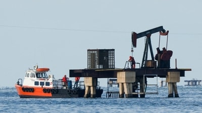 Workers of Venezuelan state oil company, PdVSA, operate a pump jack in Lake Maracaibo. Workers of Venezuelan state oil company, PdVSA, operate a pump jack in Lake Maracaibo.