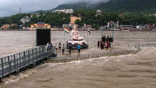 Weather today highlights: People gathered on a portion of the Parmarth Niketan Ghat that remains above water amid rising water levels following rainfall in Rishikesh on Tuesday. Weather today highlights: People gathered on a portion of the Parmarth Niketan Ghat that remains above water amid rising water levels following rainfall in Rishikesh on Tuesday.