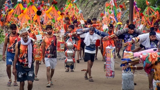 'Kanwariyas' proceed to collect holy water of the Ganga river during the annual 'Kanwar Yatra', in Haridwar, Uttarakhand.