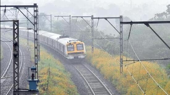 Pune, India - October 12, 2020:The Pune-Lonavla local train started on Monday for the essential service personnel, in amid foggy weather, a local train passes from a stretch of flowers before entering to Ghorawadi Station in Pune, India, on Munday, October 12, 2020.(HT PHOTO)