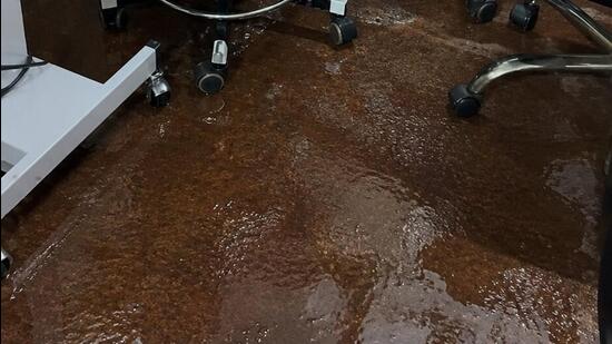Videos showed patients and attendants wading through ankle-deep water, with buckets placed across the building to collect rainwater from leaking roofs. (Sourced)
