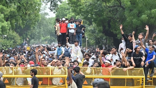 Students celebrate after the education minister's resignation at Jantar Mantar in Delhi