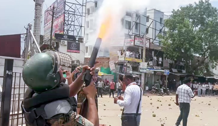 A security official launches tear gas following the alleged stone-pelting by protesters on police during the 'Bihar Bandh', called by left-wing student organisations over the alleged NEET paper leak and police action against protesting students. (ANI ) A security official launches tear gas following the alleged stone-pelting by protesters on police during the 'Bihar Bandh', called by left-wing student organisations over the alleged NEET paper leak and police action against protesting students. (ANI )
