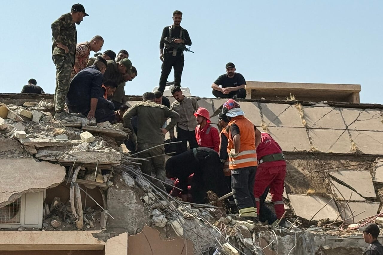 Emergency personnel work at the site of a U.S.-Saudi strike targeting Iran-backed groups in Iraq. Emergency personnel work at the site of a U.S.-Saudi strike targeting Iran-backed groups in Iraq.