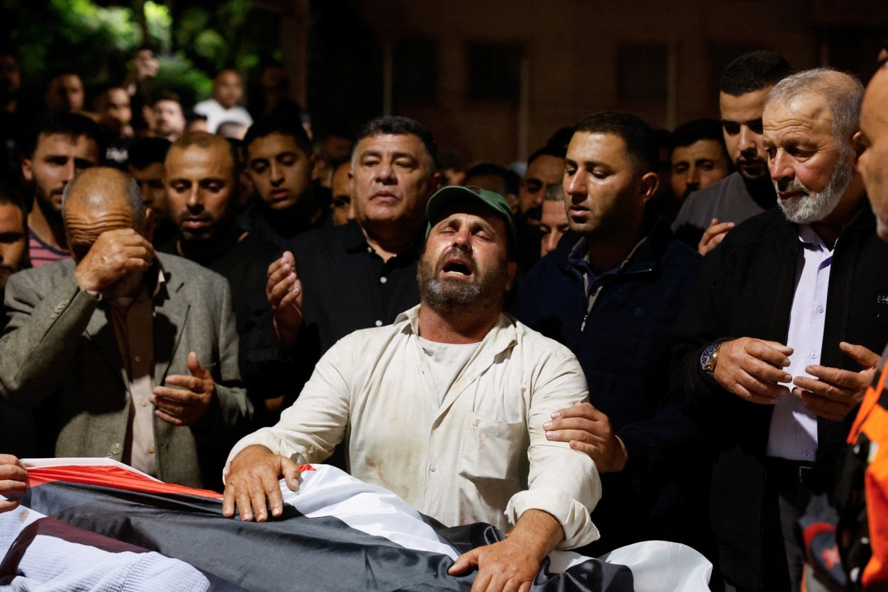 Mourners react at the funeral for Palestinians killed in the Israeli-occupied West Bank. Mourners react at the funeral for Palestinians killed in the Israeli-occupied West Bank.