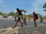 A Kanwariya carrying holy water from the Ganga River Haridwar on his shoulders while returning to Firozpur Jhirka in Nuh district during the Kanwar Yatra(Parveen Kumar/Hindustan Times)