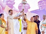 Chief minister Yogi Adityanath holds a mace during the inauguration and foundation stone laying of 268 public welfare projects worth  <span class='webrupee'>₹</span>692 crore, in Ghazipur on Thursday. ((@myogiadityanath X/ANI Photo))