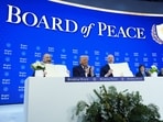 US President Donald Trump and other leaders hold up their signed Board of Peace charter during the Annual Meeting of the World Economic Forum