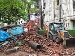 Mud, Debris and earthmoving machinery at the site as rescue personnel conduct rescue operations after a portion of the Kohinoor Building in Balaji Nagar area of the powerloom town collapsed.