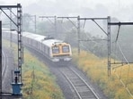 Pune, India - October 12, 2020:The Pune-Lonavla local train started on Monday for the essential service personnel, in amid foggy weather, a local train passes from a stretch of flowers before entering to Ghorawadi Station in Pune, India, on Munday, October 12, 2020.(HT PHOTO)