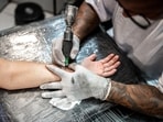 An artist working on a tattoo.