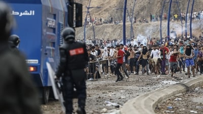 Moroccan security forces clash with migrants attempting to cross into Spain's North African enclave of Ceuta near the town of Fnideq, on the Morocco-Spain border, on July 31. (AFP) Moroccan security forces clash with migrants attempting to cross into Spain's North African enclave of Ceuta near the town of Fnideq, on the Morocco-Spain border, on July 31. (AFP)