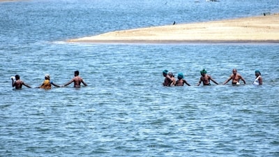Farmers led by an association form a human chain as they wade into Cauvery river to protest over water dispute, in Tiruchirappalli district of Tamil Nadu. (PTI) Farmers led by an association form a human chain as they wade into Cauvery river to protest over water dispute, in Tiruchirappalli district of Tamil Nadu. (PTI)