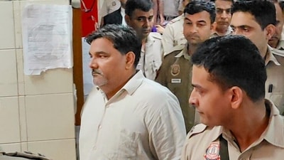 Former AAP councillor Tahir Hussain being escorted by police personnel as he leaves after a hearing in the case of the murder of Intelligence Bureau officer Ankit Sharma during the 2020 Delhi riots. (PTI) Former AAP councillor Tahir Hussain being escorted by police personnel as he leaves after a hearing in the case of the murder of Intelligence Bureau officer Ankit Sharma during the 2020 Delhi riots. (PTI)