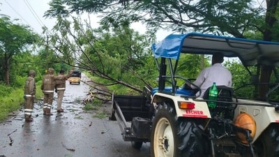 Police personnel help to clear the site of a tree collapse due to heavy rainfall in Jagtial district on Thursday. (HT PHOTO) Police personnel help to clear the site of a tree collapse due to heavy rainfall in Jagtial district on Thursday. (HT PHOTO)