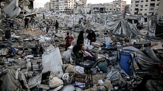 Palestinians inspect the debris following an Israeli airstrike the day before in Gaza City, Gaza, on Thursday, July 30, 2026.