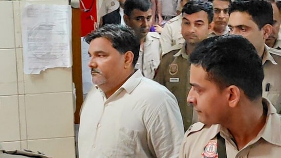 Former AAP councillor Tahir Hussain being escorted by police personnel as he leaves after a hearing in the case of the murder of Intelligence Bureau officer Ankit Sharma during the 2020 Delhi riots.