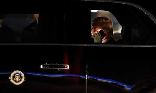 FILE - President Donald Trump talks on his cell phone in his limousine, known as "The Beast," upon his arrival at Joint Base Andrews, Md., March 6, 2026.