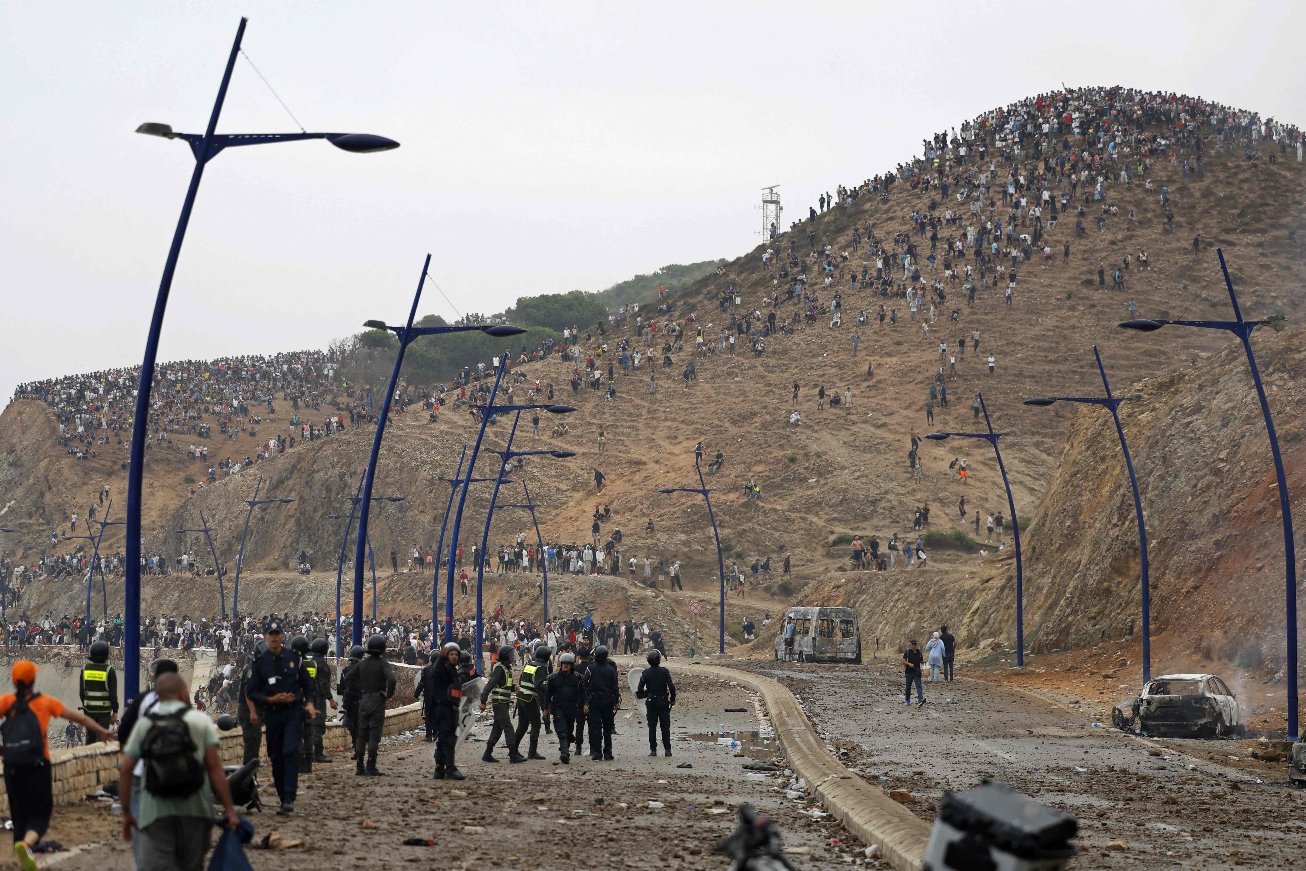 Members of Moroccan security forces gather at the site of clashes near Fnideq, on the Morocco-Spain border. (AFP) Members of Moroccan security forces gather at the site of clashes near Fnideq, on the Morocco-Spain border. (AFP)