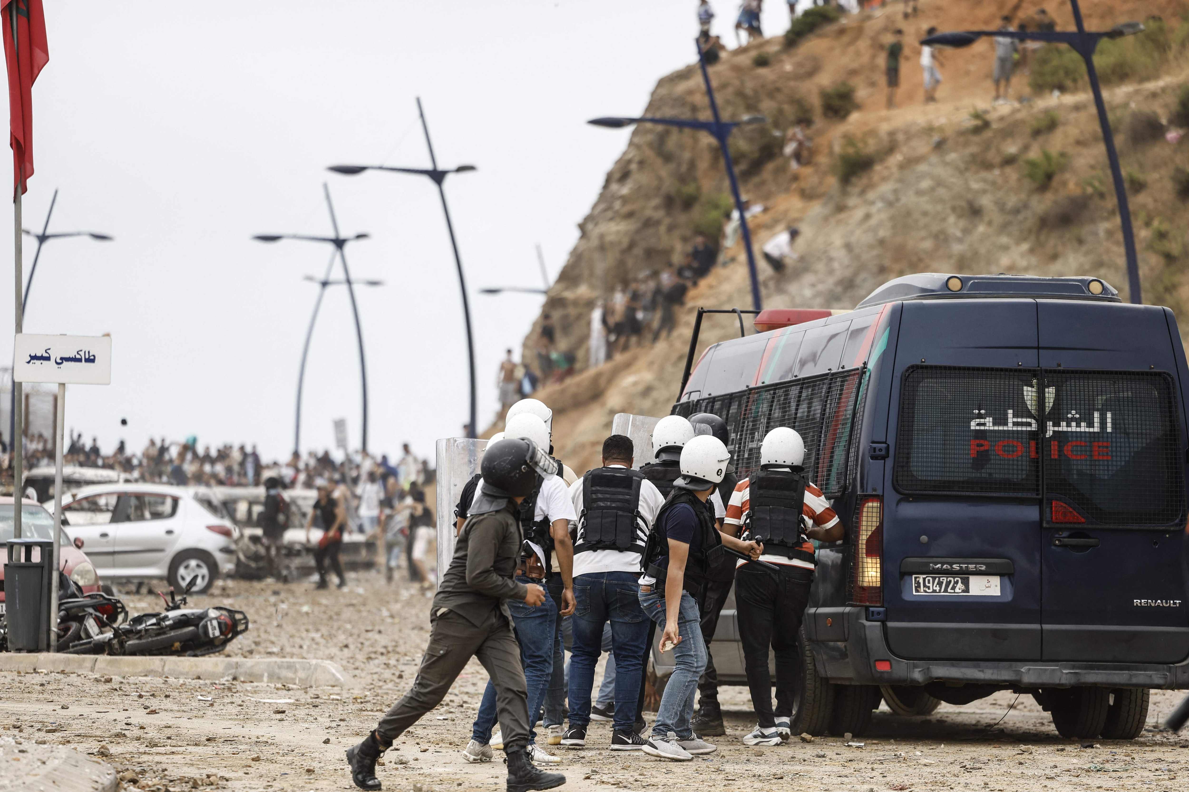 Moroccan security forces clash with migrants attempting to cross into Spain's North African enclave of Ceuta near the town of Fnideq, on the Morocco-Spain border, on July 31, 2026. (AFP) Moroccan security forces clash with migrants attempting to cross into Spain's North African enclave of Ceuta near the town of Fnideq, on the Morocco-Spain border, on July 31, 2026. (AFP)