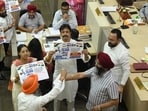 Congress and AAP members protesting during the MC House meeting at the Municipal Corporation office in Sector 17, Chandigarh, on Friday. (Keshav Singh/HT)