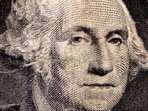 The image of first US president George Washington on a dollar bill is seen in a photo illustration.