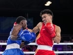 Jadumani Singh Mandengbam, red, and Namibia's Philip Pumulo Mutakela Haoseb in action.