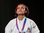 Asmita Dey poses with her gold medal during the victory ceremony for the Women's 48kg judo event at the Commonwealth Games,
