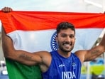 India's Tejaswin Shankar celebrates with the national flag after winning the bronze medal in the men's decathlon event at Commonwealth Games 2026.
