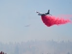 Representational image of fire retardant being dropped by air tanker onto a fire.