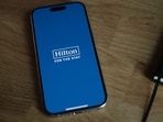 The Hilton app is seen on a phone.(Unsplash)