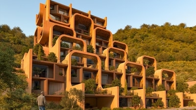 In Tirana, Albania, a terracotta township called The Nest blends into the hillside with curved lines, terraced architecture, and terracotta and red stucco facades. The design by the award-winning UK-based Zaha Hadid Architects embraces the uneven topography, using it to create overhanging balconies and recessed terraces for each home. In Tirana, Albania, a terracotta township called The Nest blends into the hillside with curved lines, terraced architecture, and terracotta and red stucco facades. The design by the award-winning UK-based Zaha Hadid Architects embraces the uneven topography, using it to create overhanging balconies and recessed terraces for each home.