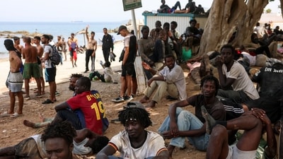 Migrants gather in Ceuta, Spain, following recent mass crossings of migrants on foot and by sea from Morocco into Spanish territory. (Reuters)