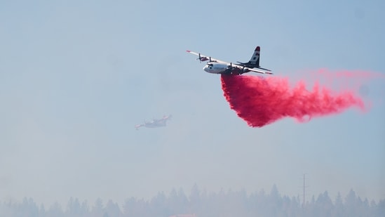 Representational image of fire retardant being dropped by air tanker onto a fire.