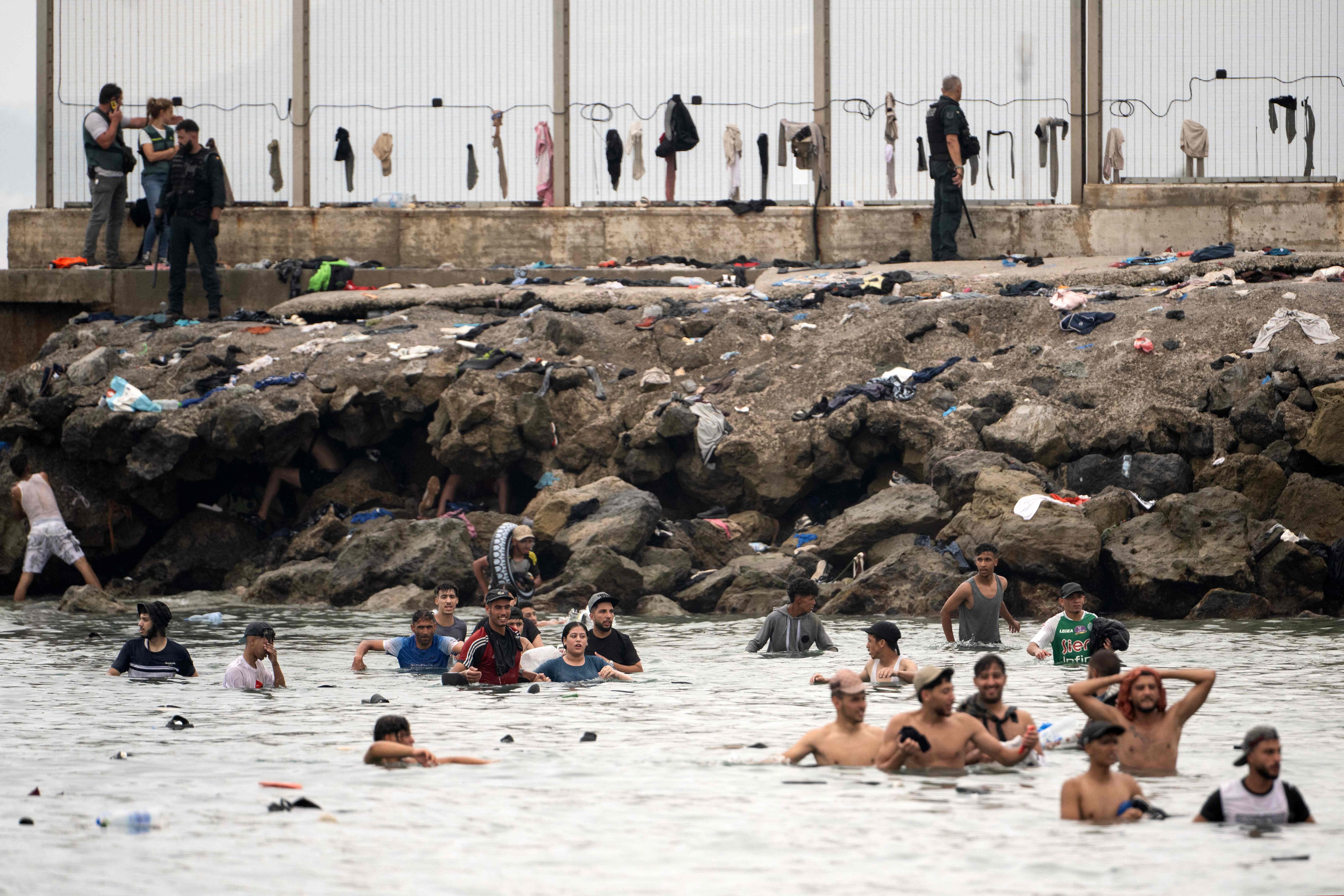 Spain's Guardia Civil officers contol as migrants try to swim through the waters close to the border with Morocco to enter Spain's north Africa's Ceuta enclave. (AFP) Spain's Guardia Civil officers contol as migrants try to swim through the waters close to the border with Morocco to enter Spain's north Africa's Ceuta enclave. (AFP)