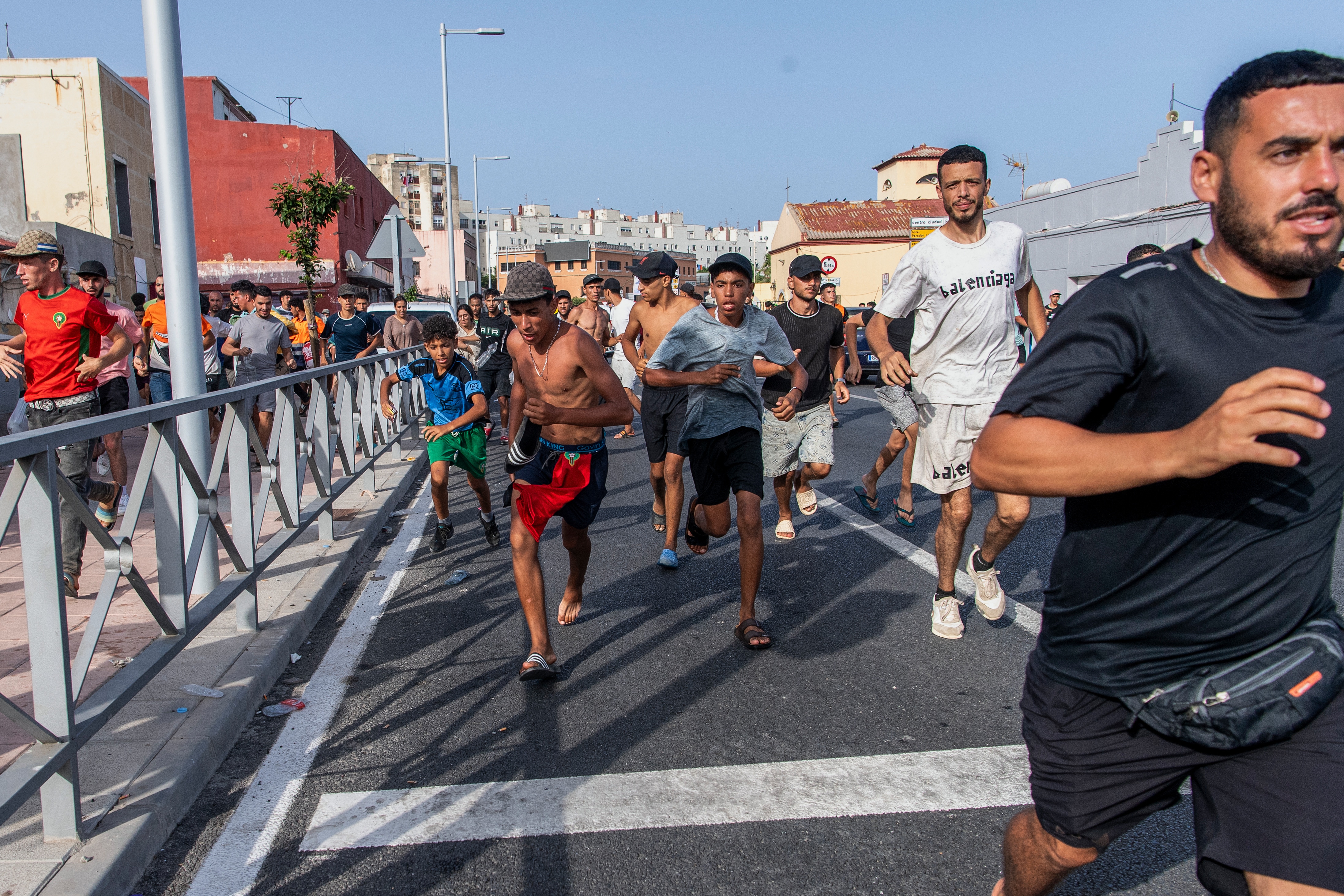 Migrants run from Spanish police officers after crossing from Morocco into the Spanish enclave of Ceuta, Friday, July 31, 2026. (File Photo/AP) Migrants run from Spanish police officers after crossing from Morocco into the Spanish enclave of Ceuta, Friday, July 31, 2026. (File Photo/AP)