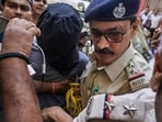 Bardhaman: West Bengal Police Special Task Force (STF) personnel escort suspected terrorist Hamid Mondal, also known as Hamim Mondal, with his face covered while producing him before a court.